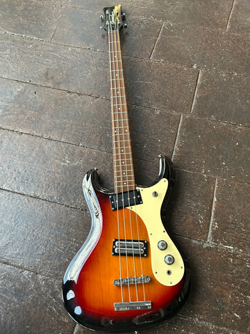 Sunburst Danelectro bass with two pick ups and chrome hardware, tan pick guard, rosewood fretboard and black headstock