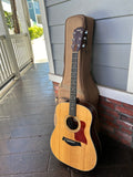 taylor guitar with tan gig bag