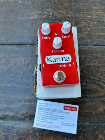 Karma ODR-10 Overdrive red guitar pedal with three control knobs and single button foot switch