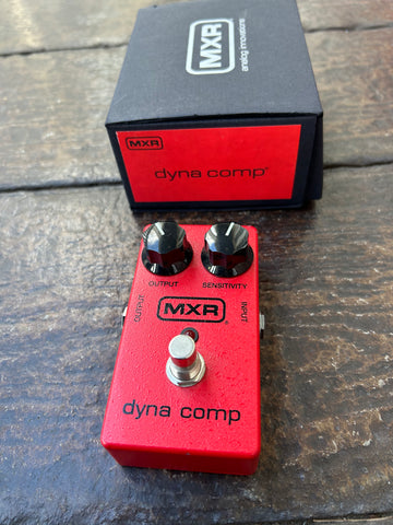 Red MXR Dyna Comp guitar pedal, two control knobs, and single button footswitch