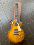 Gibson Les Paul honeyburst, with chrome hardware and two chrome pick-ups, rosewood fretboard with trapezoid inlays, black Gibson headstock