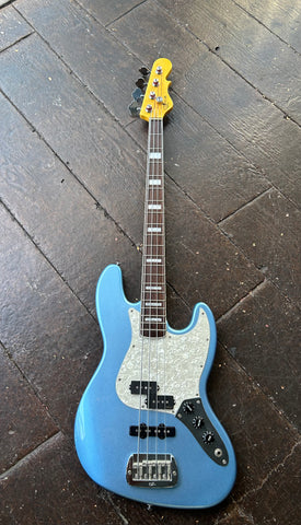 Light blue G&L JB Bass with black pick ups, white pick-guard, rosewood fretboard with block inlays and maple headstock