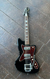 Top View black Silvertone with tortoise pickguard, two metal pick ups, five yellow control know, rosewood fretboard with block inlays, black headstock, white tuners, Silvertone script in gold 