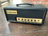 Black Friedman guitar amplifier hear, with gold control panel, black knobs