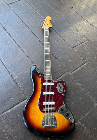 Squier Bass VI sunburst with chrome hardware, tortoise pick guard, three single coil pickups with white covers, rosewood fretboard with block inlays, maple headstock 